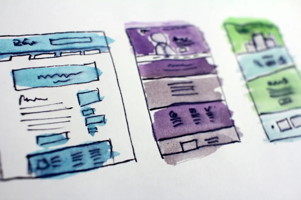 Watercolour wireframe sketches of website page layouts